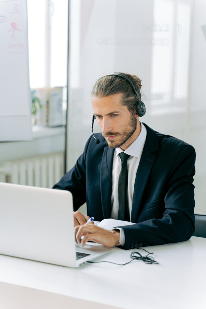 A professional loan officer is checking options on a computer in an office, focusing on international business startup loans