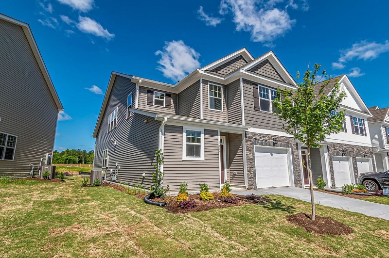 Exterior view of a modern single-family house with large windows, ideal for estate loans and real estate investments