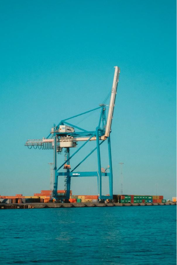 Cargo ship transporting export equipment across the sea, symbolizing export - import financing for global trade.